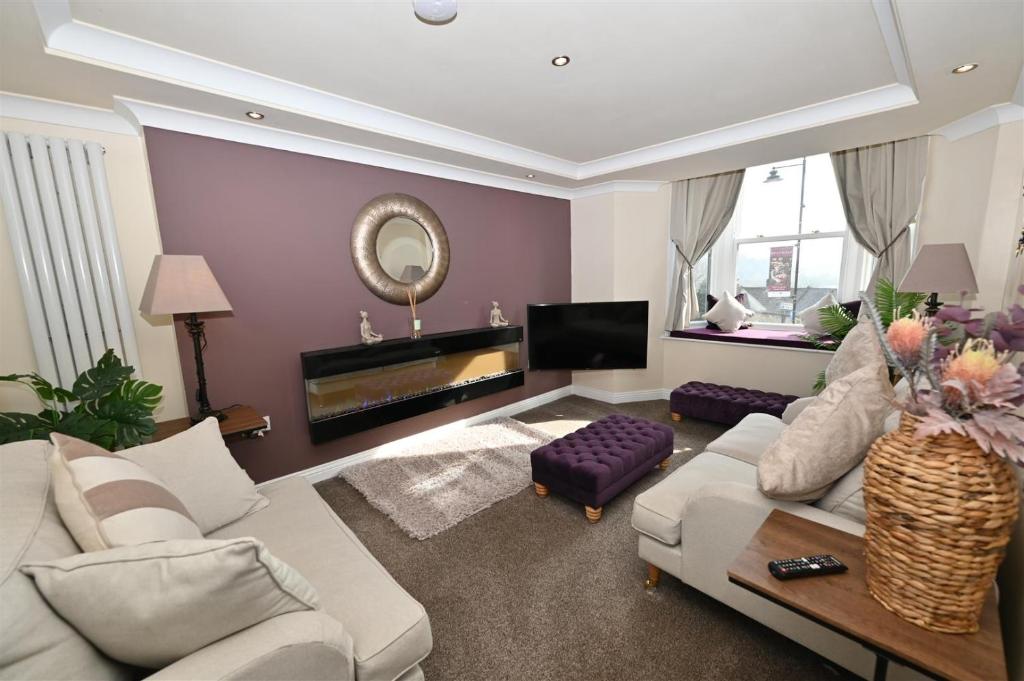 a living room with a white couch and a mirror at Church View Richmond - spacious, 2 bed ensuite luxury apartment in town centre in Richmond