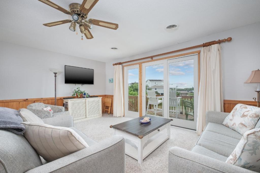 a living room with two couches and a tv at 4209 - Moby Duck in Duck