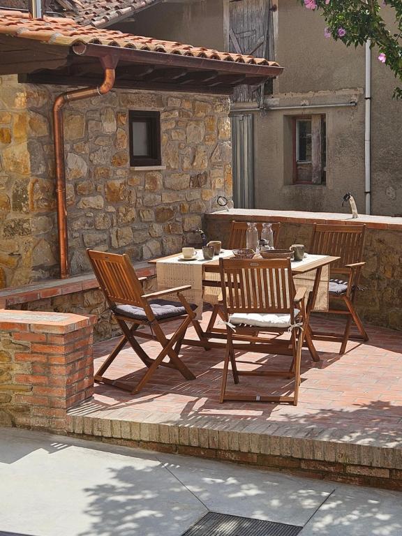 a wooden table and chairs on a patio at Villanueva 5 in Luces