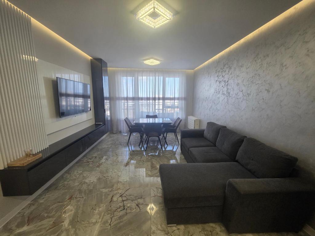 a living room with a couch and a table at arena sunrise in Burgas