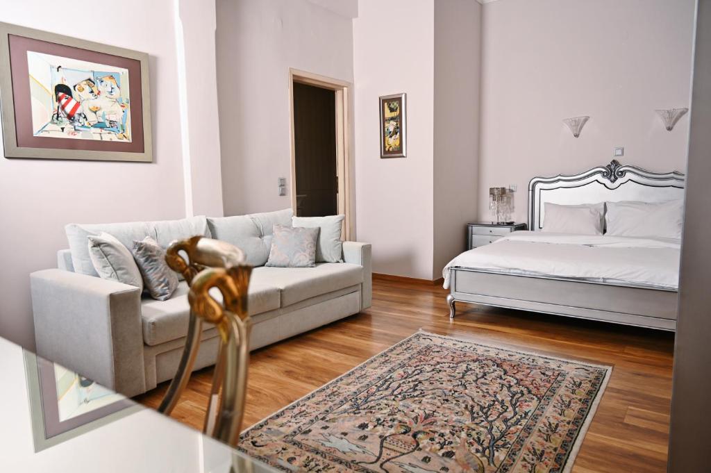 a living room with a couch and a bed at Le Bijou Luxury Rooms & Suites in Veria