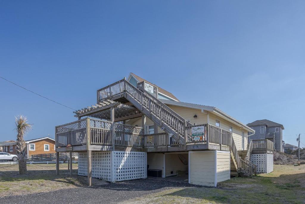 a house with balconies on the side of it at 7039 - A Wave From It All in Rodanthe