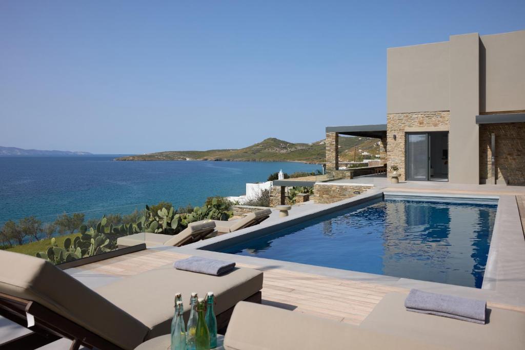 a villa with a swimming pool and a view of the ocean at Villa Apollo in Kionia