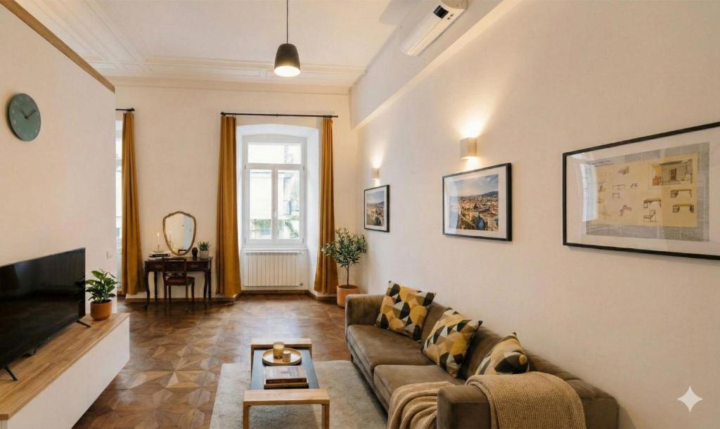 a living room with a couch and a tv at L'arco Trieste studio living 2 in Trieste
