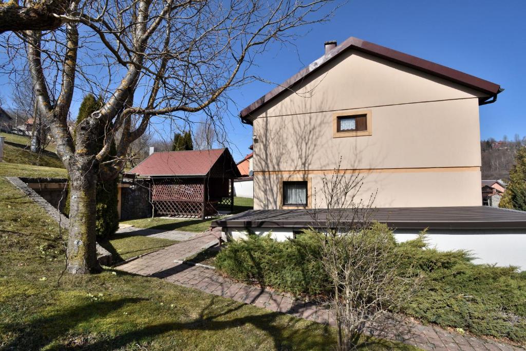 a white house with a red roof at Apartment Tadey in Fužine