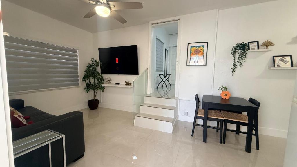 a living room with a couch and a table at Comfortable modern apartment- central location. in Miami