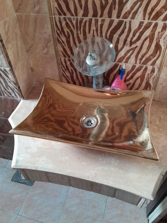a shower with a wooden tub in a bathroom at El Basha Apartment sea View in Dumyāţ al Jadīdah