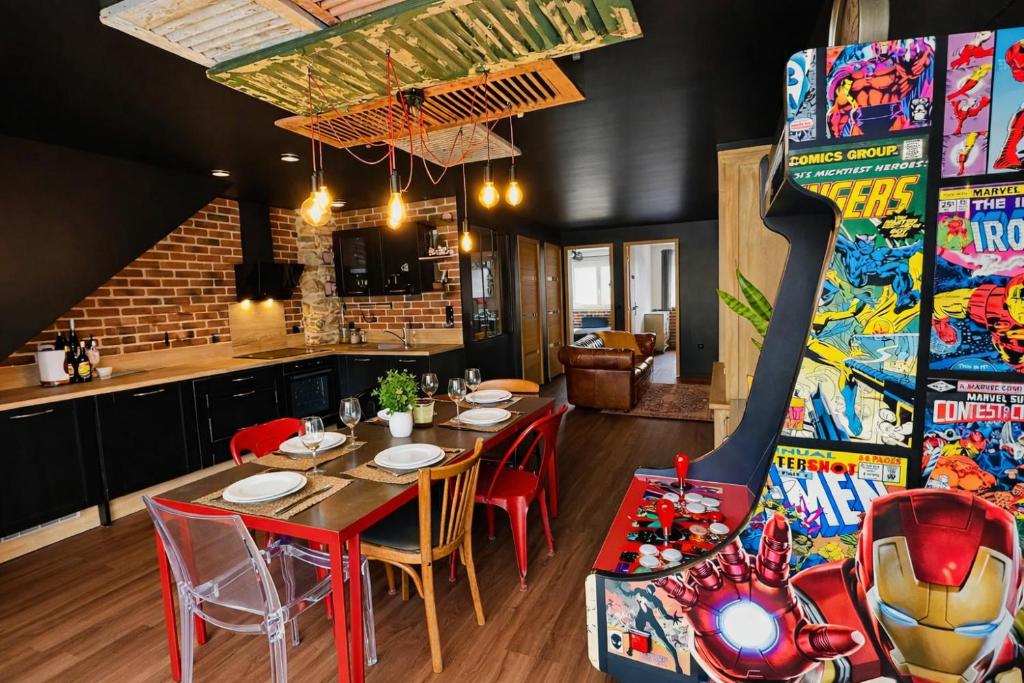 a dining room with a table and a game room at Artist Retro Disneyland Paris P3 in Coutevroult