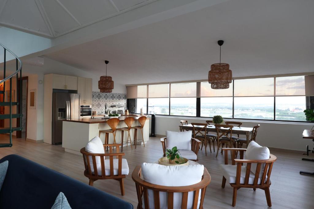 a living room and kitchen with a table and chairs at Attractive Penthouse in Isla Verde in San Juan