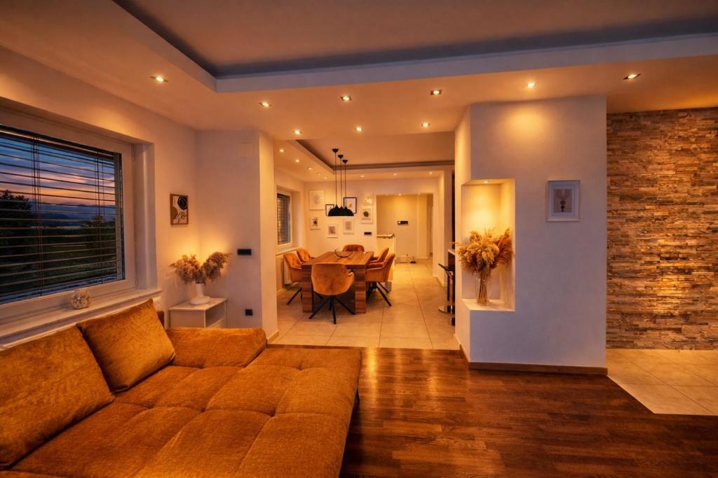 a living room with a couch and a dining room at Vila SofiOmi in Bled