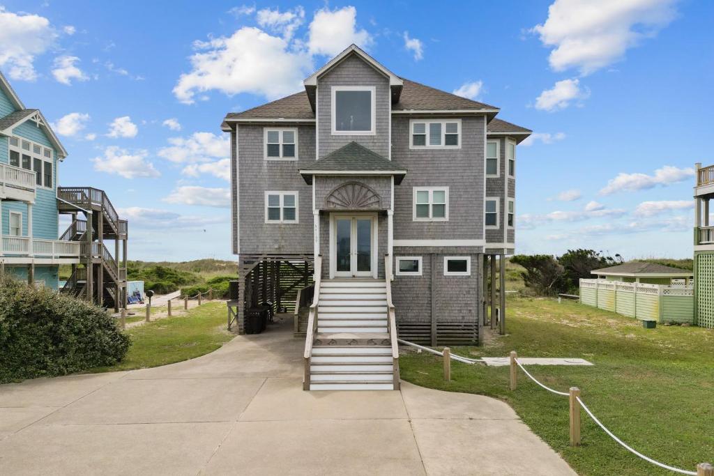 a large house with stairs leading up to it at 7865 - Peridot in Frisco