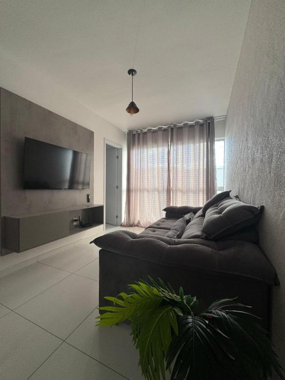 a bedroom with a large bed and a television at Dona Olivia Universidade 16 in Vitória da Conquista
