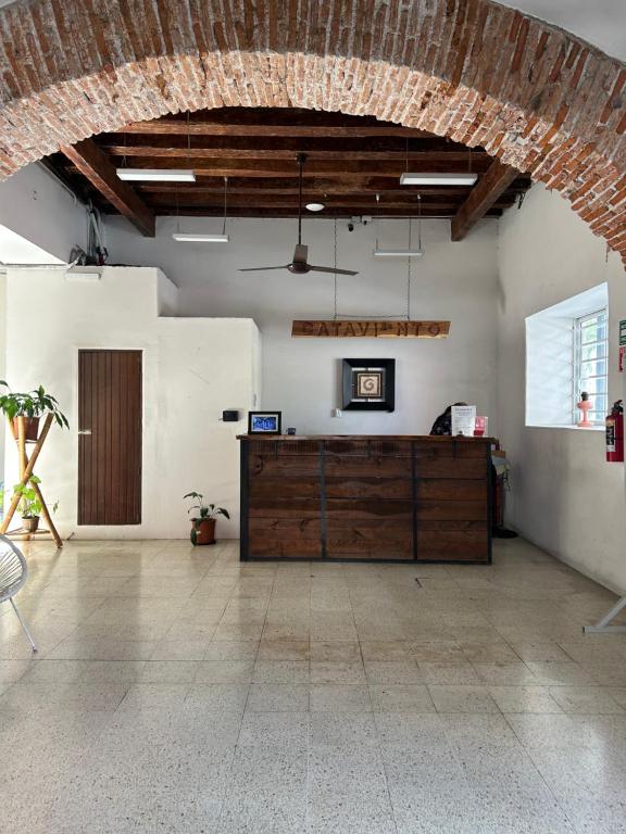 a large room with a wooden desk in the middle of a room at Hotel Cataviento in Veracruz