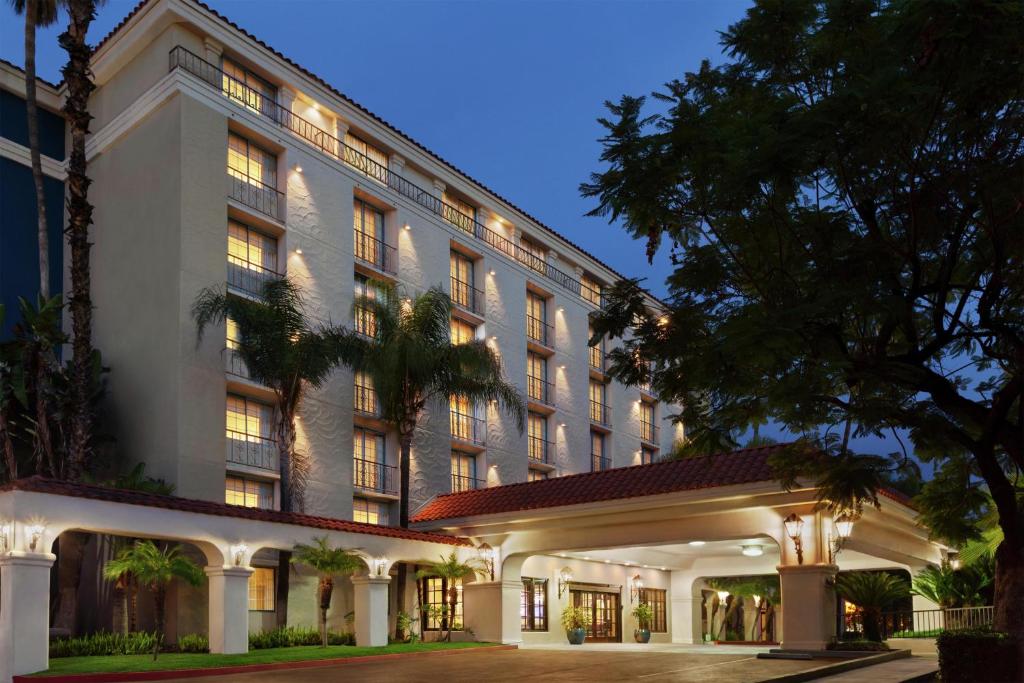 an exterior view of a hotel at night at Embassy Suites by Hilton Arcadia-Pasadena Area in Arcadia