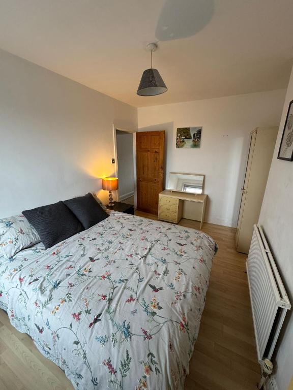 a bedroom with a large bed in a room at Spacious Bournemouth Apartment in Bournemouth