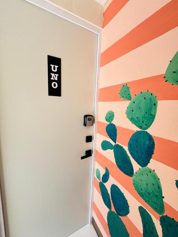 a room with a cactus painted on the wall at Suite 02 Montenegro Cerca de Consulado in Monterrey