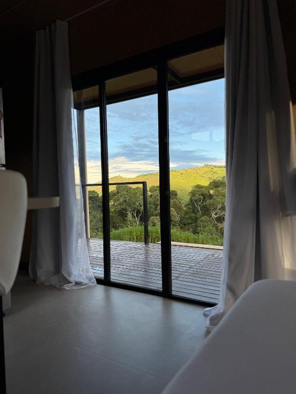 a room with a window with a view of a deck at Villa D Castro in Gonçalves