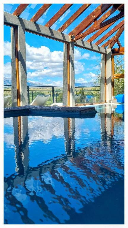 a swimming pool with a view of the water at Arroyo Escondido in Trevelín