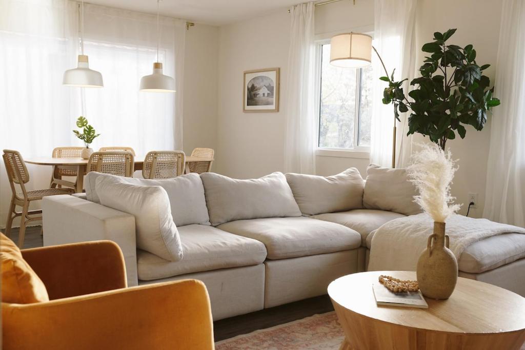 a living room with a white couch and a table at Soleil House in Fort Saint John