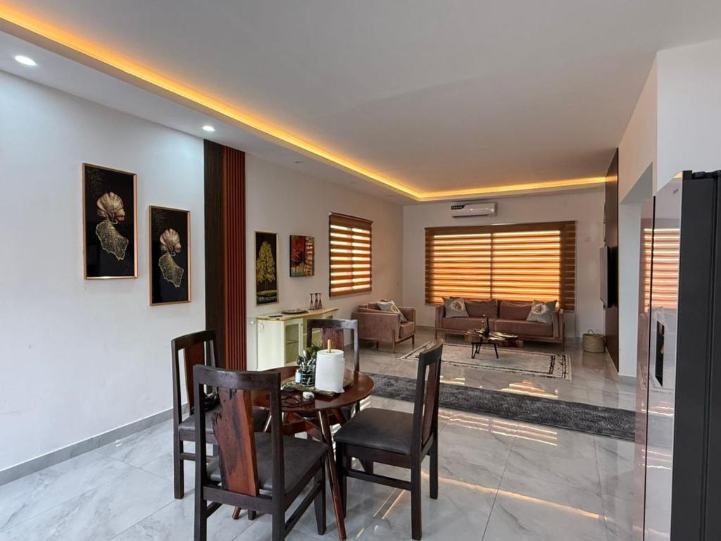a living room with a table and chairs at Samash villa foxdale 2 bedroom in Lusaka