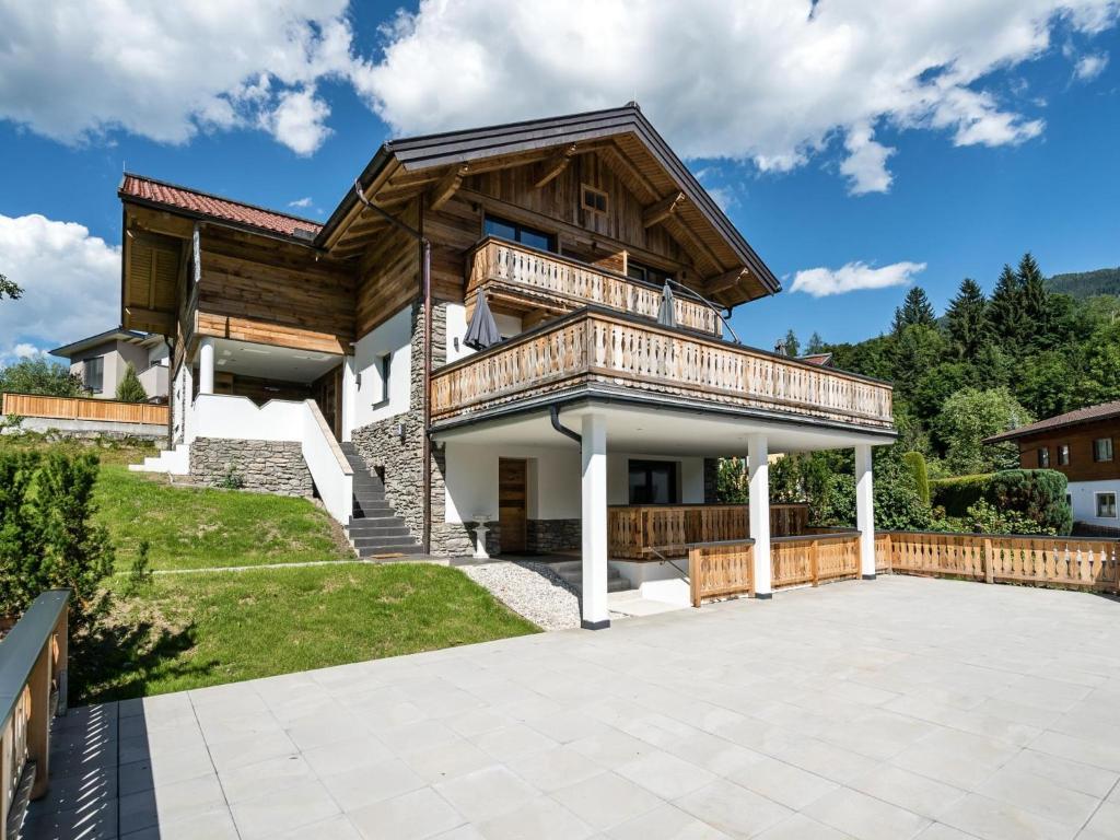 a house with a large patio in front of it at Mozart Lodge in Wagrain