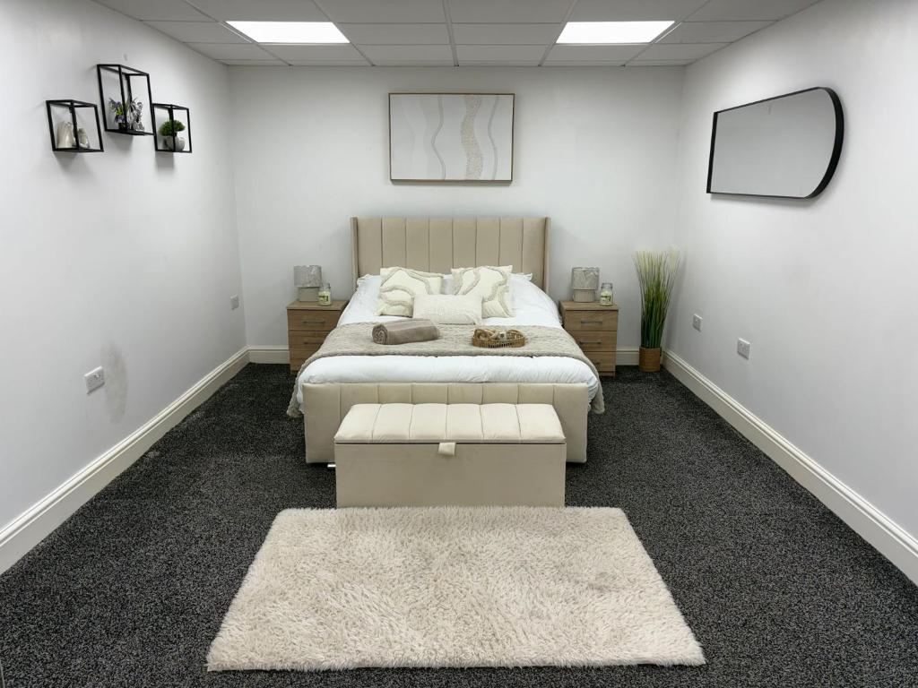 a bedroom with a bed and a table and mirrors at The Shepherd in Hunslet