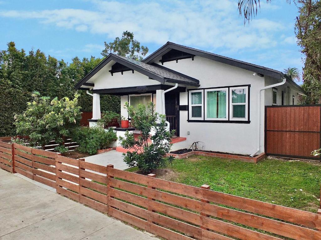 a house with a wooden fence in front of it at Charming Craftsman - Beach Close in Long Beach