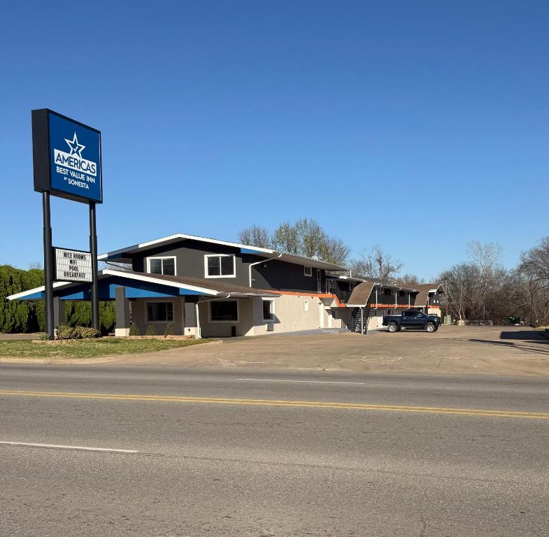 a building with a sign on the side of a road at Americas Best Value Inn Ponca City in Ponca City