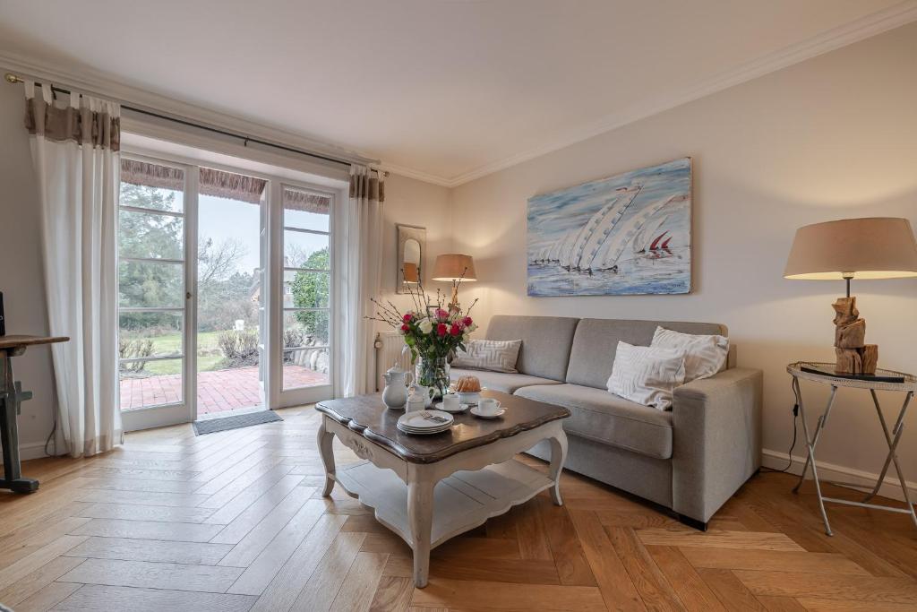 a living room with a couch and a table at Deichgraf 4 in Kampen