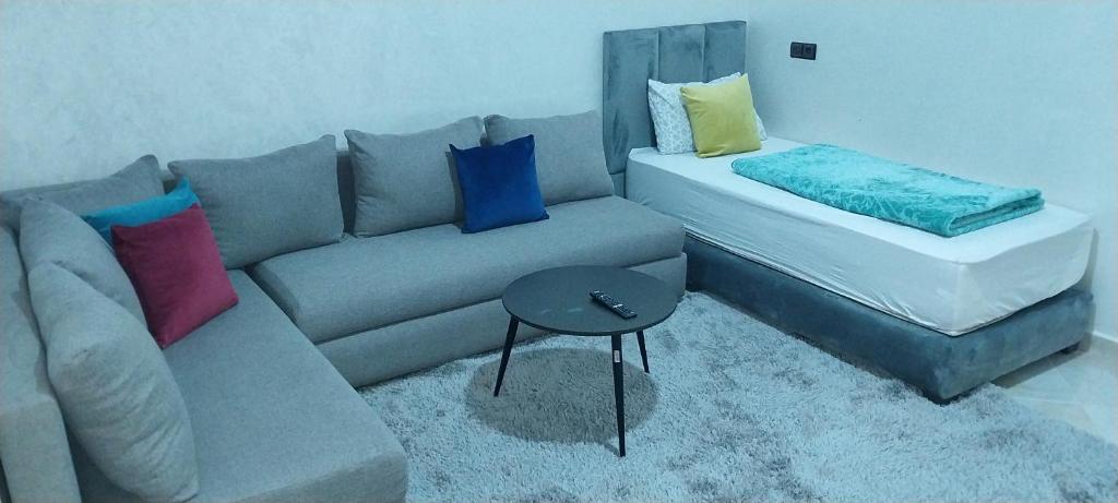 a living room with a couch and a table at rooms maissa 1 in Cabo Bojador