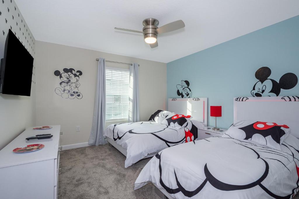 a bedroom with two twin beds with batman beds at Stunning Townhouses 5 Minutes away Disney! in Kissimmee