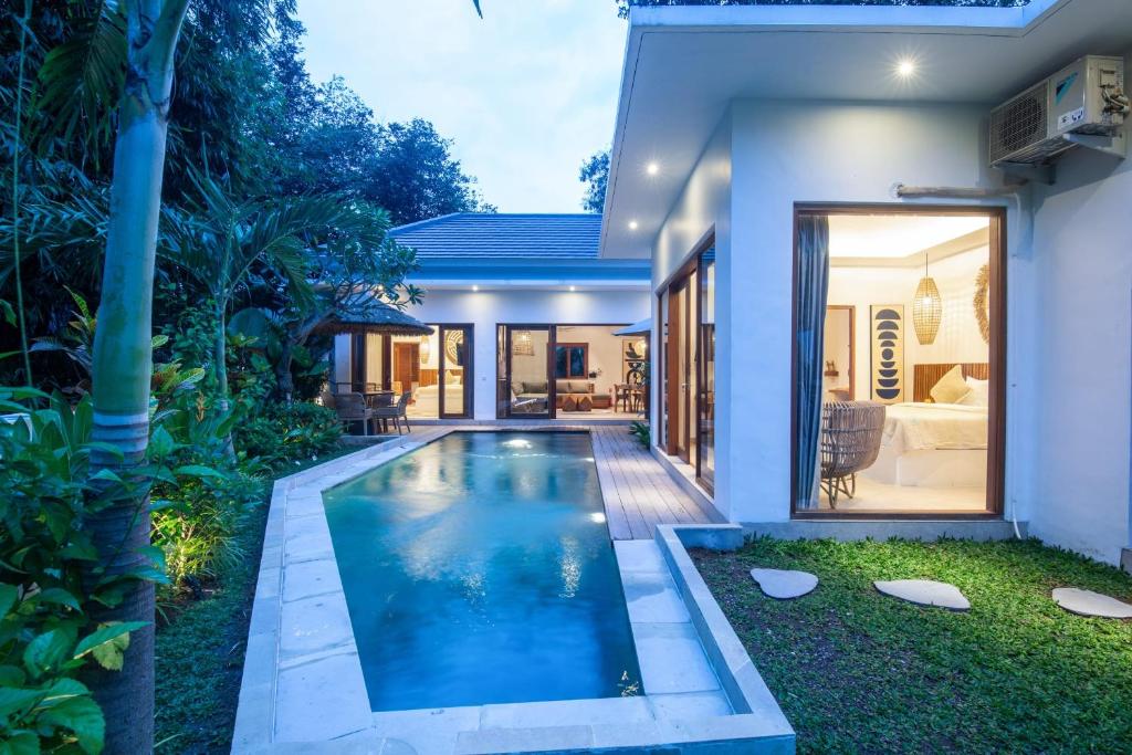 a swimming pool in the backyard of a house at Villa Jacelyne - Tropical 2BR Villa with Private Pool in Canggu in Dalung