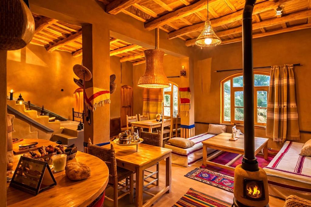 a living room with a wood stove in a room at Riad pizzeria Marhaba in Akhendachou nʼAït Ouffi