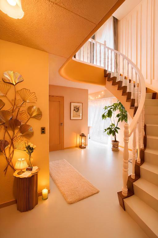 a living room with a staircase and a stair case at 天然温泉付別荘in海友荘 in Shirahama