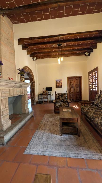 a living room with a couch and a fireplace at Casa del Rey in Taxco de Alarcón