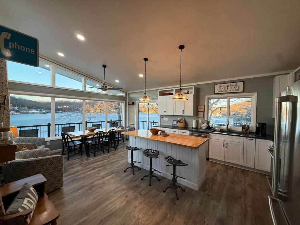 a kitchen and living room with a table and chairs at Lucky Duck Lakefront Fire Pit in Gravois Mills
