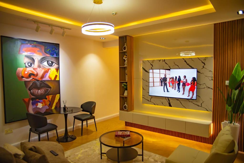 a living room with a tv on a wall at LetMax Homes in Ikeja