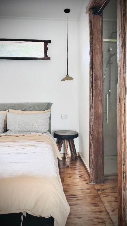 a bedroom with a bed and a table and a shower at Bluff Shacks in Whitemark