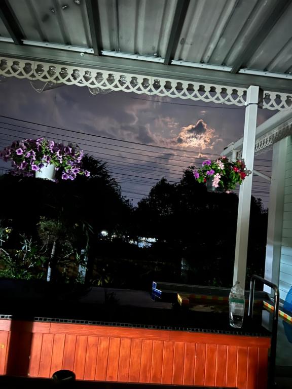 a window with two potted flowers on it at Charming quirky Thai style house in Hua Hin