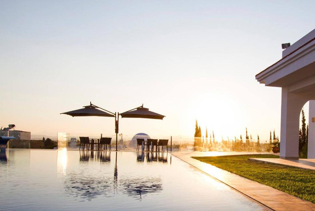 a pool with chairs and umbrellas in the water at ksour in Tunis