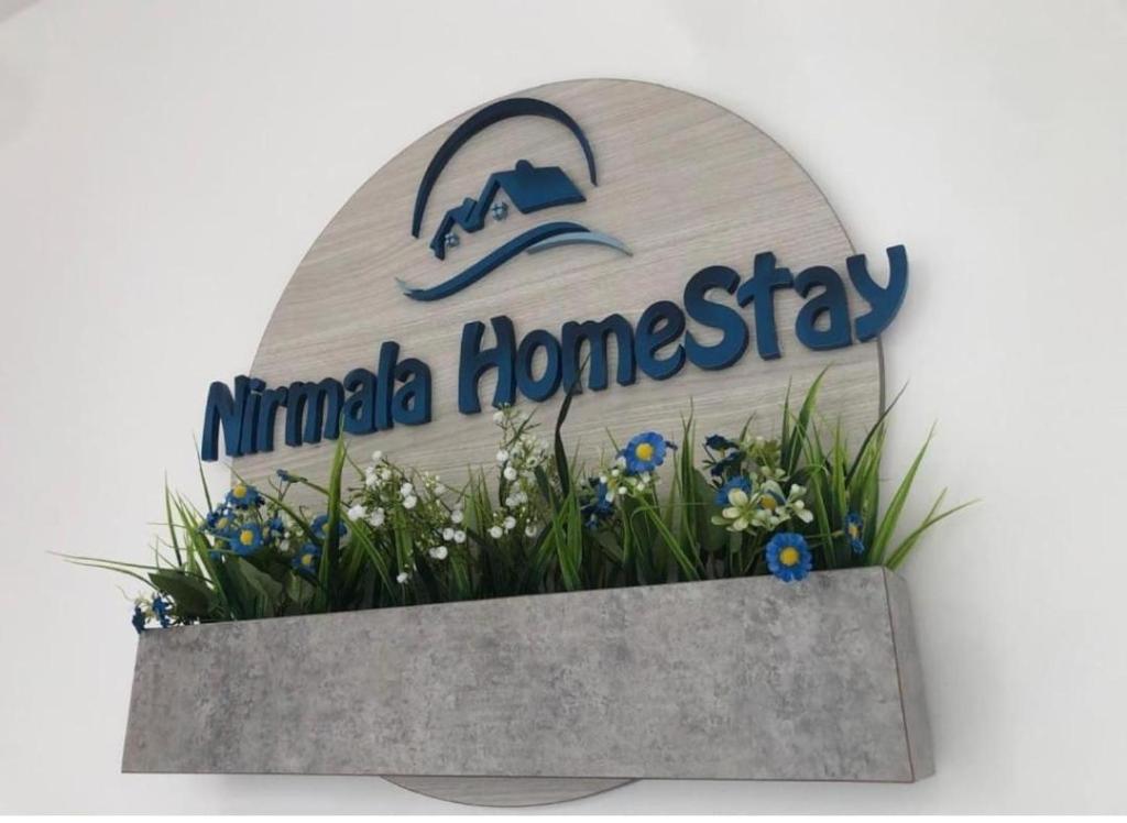 a sign for a miami homesay sign at Nirmalahomestay in Polgasowita