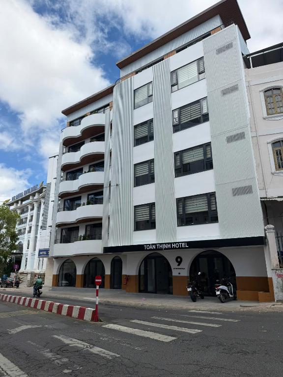 a large white building on the corner of a street at Toàn Thịnh Hotel in Da Lat