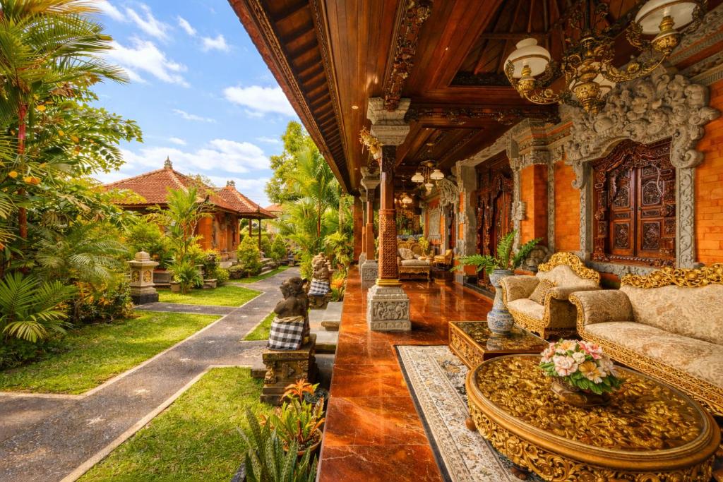 a living room with a couch in a house at Puri Anyar Ubud by Puri Signatures in Ubud