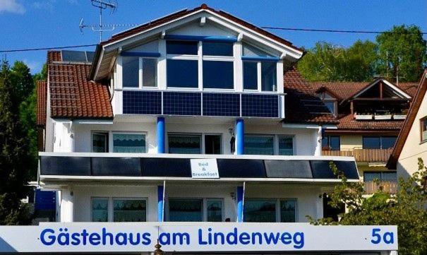 a white house with a sign in front of it at Gästehaus am Lindenweg in Meersburg