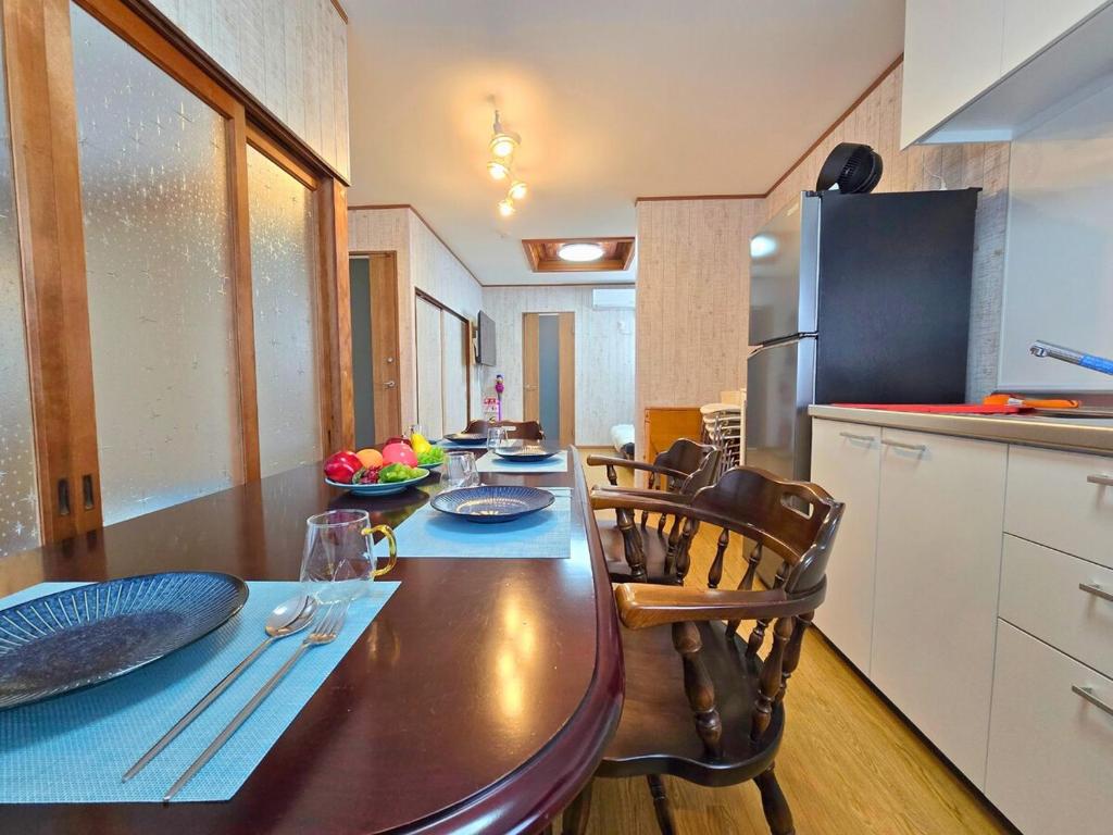 a kitchen with a table and chairs in a kitchen at sora in Osaka