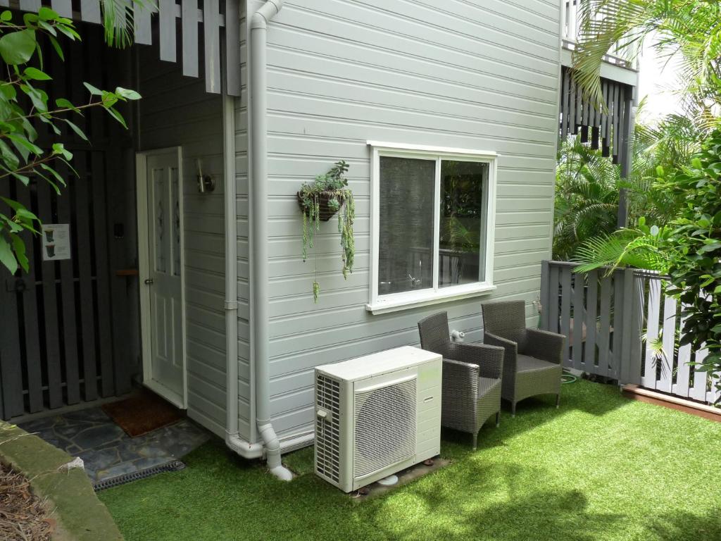 a patio with a heater on the side of a house at Bushland Breeze - Self Contained Unit in Gladstone