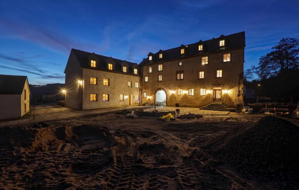 a large building with lights on at night at Munkler Mühle Whg 1 in Irrhausen