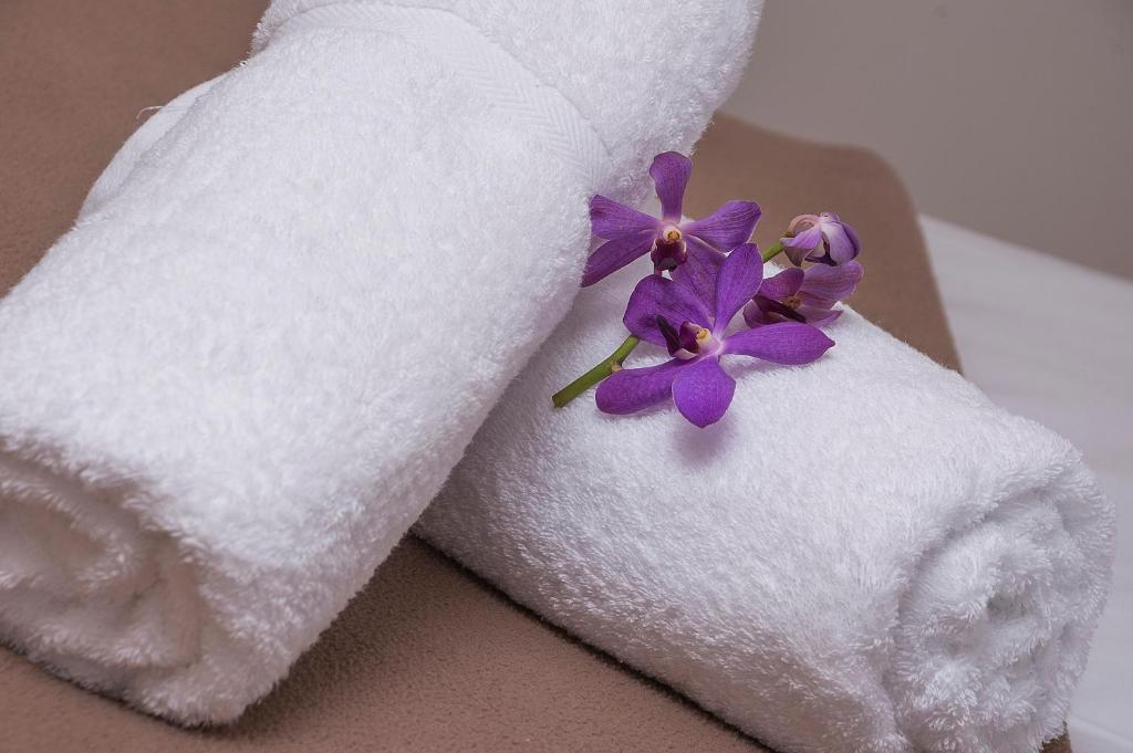 a pair of towels with purple flowers on them at Sunshine Beach Resort in Gold Coast