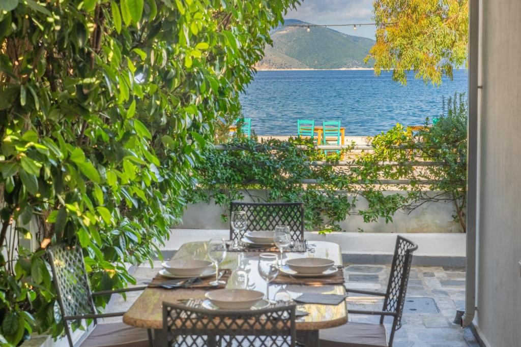 a table and chairs with a view of the ocean at Olvio Living by the Sea in Sami