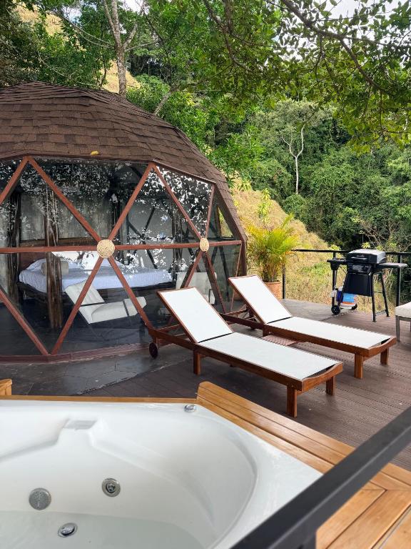 a hot tub on a deck with a gazebo at Domo Alto del Monte in Alto del Monte